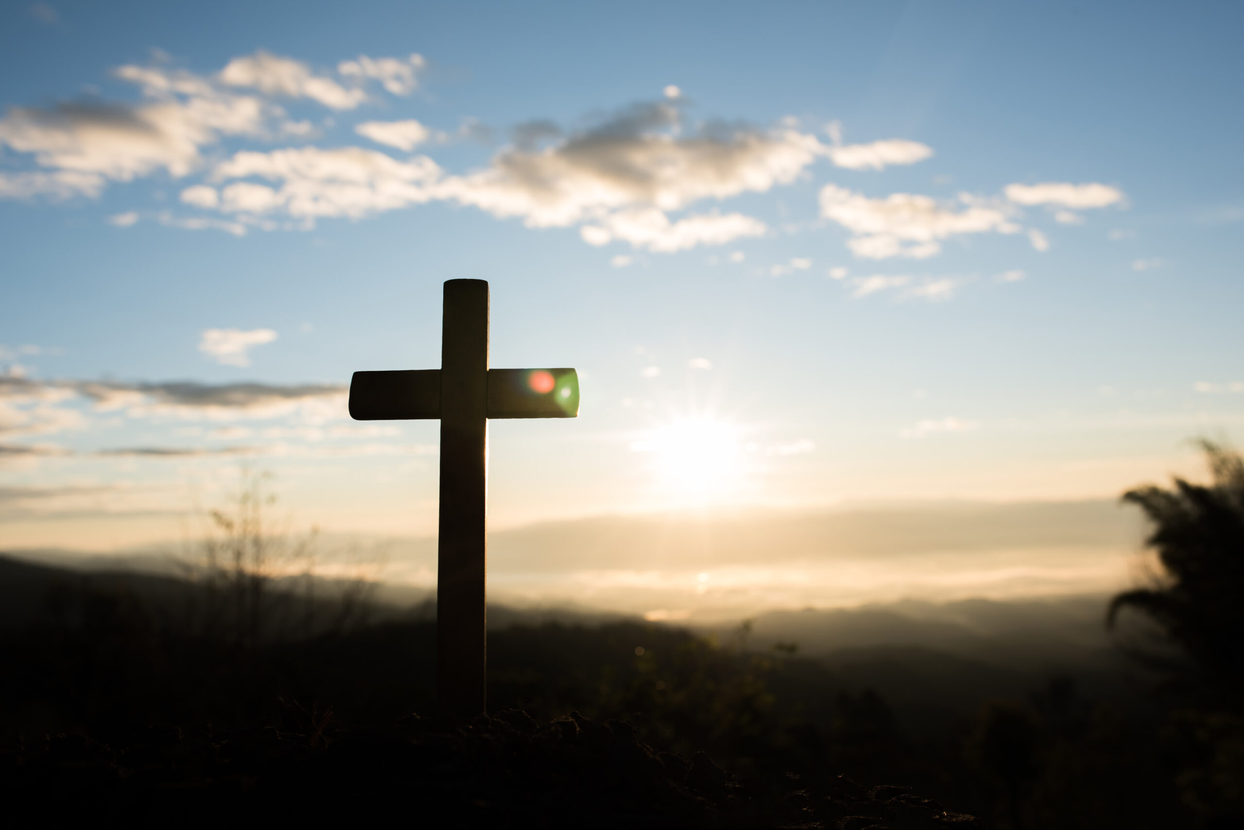 Silhouette of catholic cross and sunrise